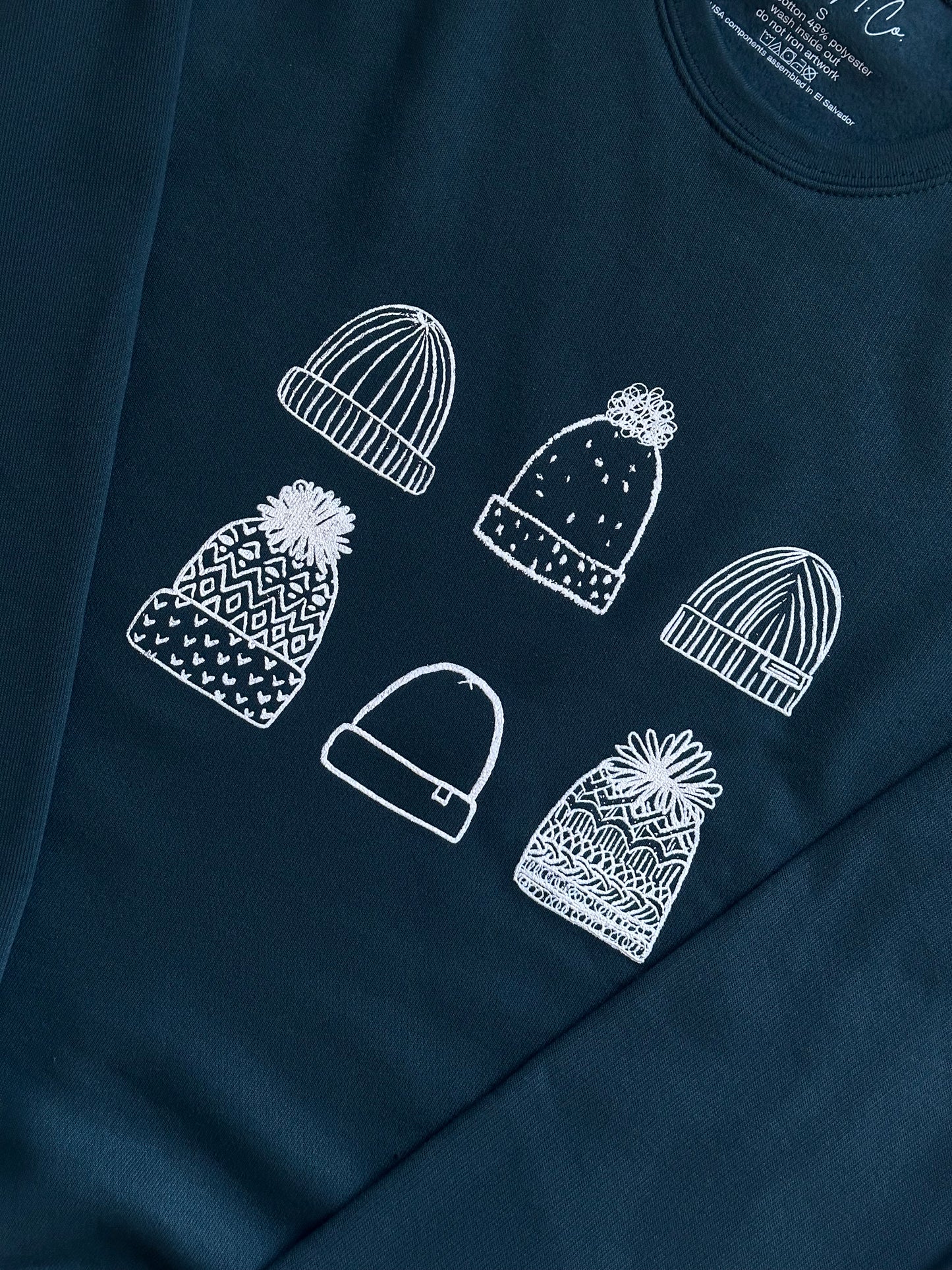 Beanies on Dark Teal Sweatshirt