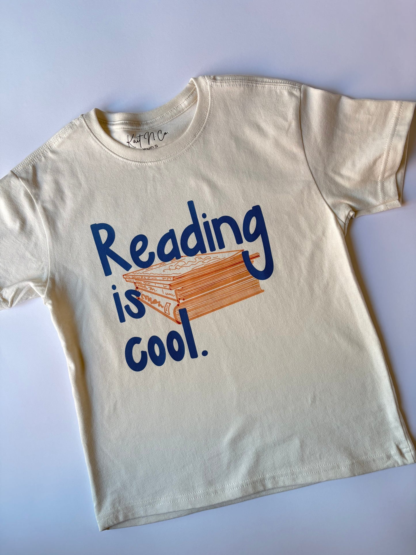 Reading is cool. on Youth Vintage White Short Sleeve Tee